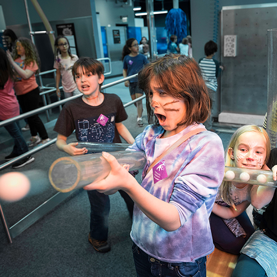 children playing with a play ball air hose